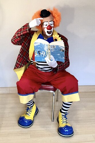 Auguste_clown_reading_a_book_upside-down