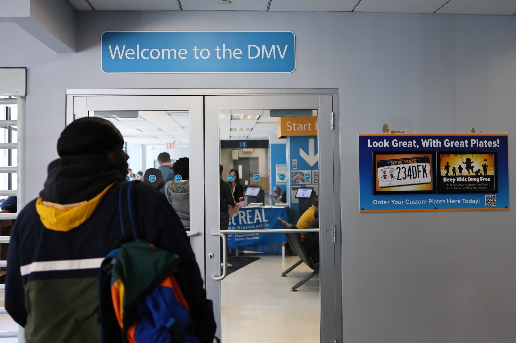 Person standing before a DMV entrance.